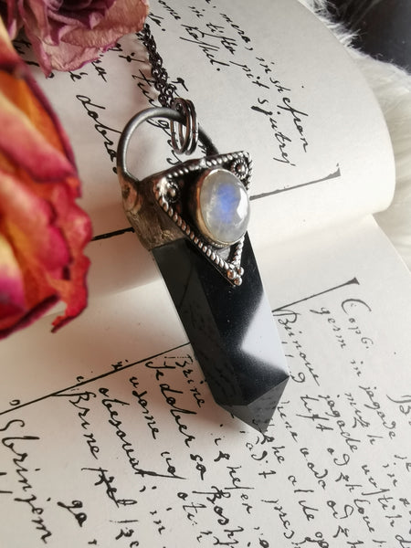 Black obsidian point pendant with moonstone crystal