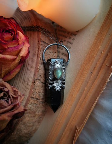 Ornate black obsidian point pendant with green labradorite